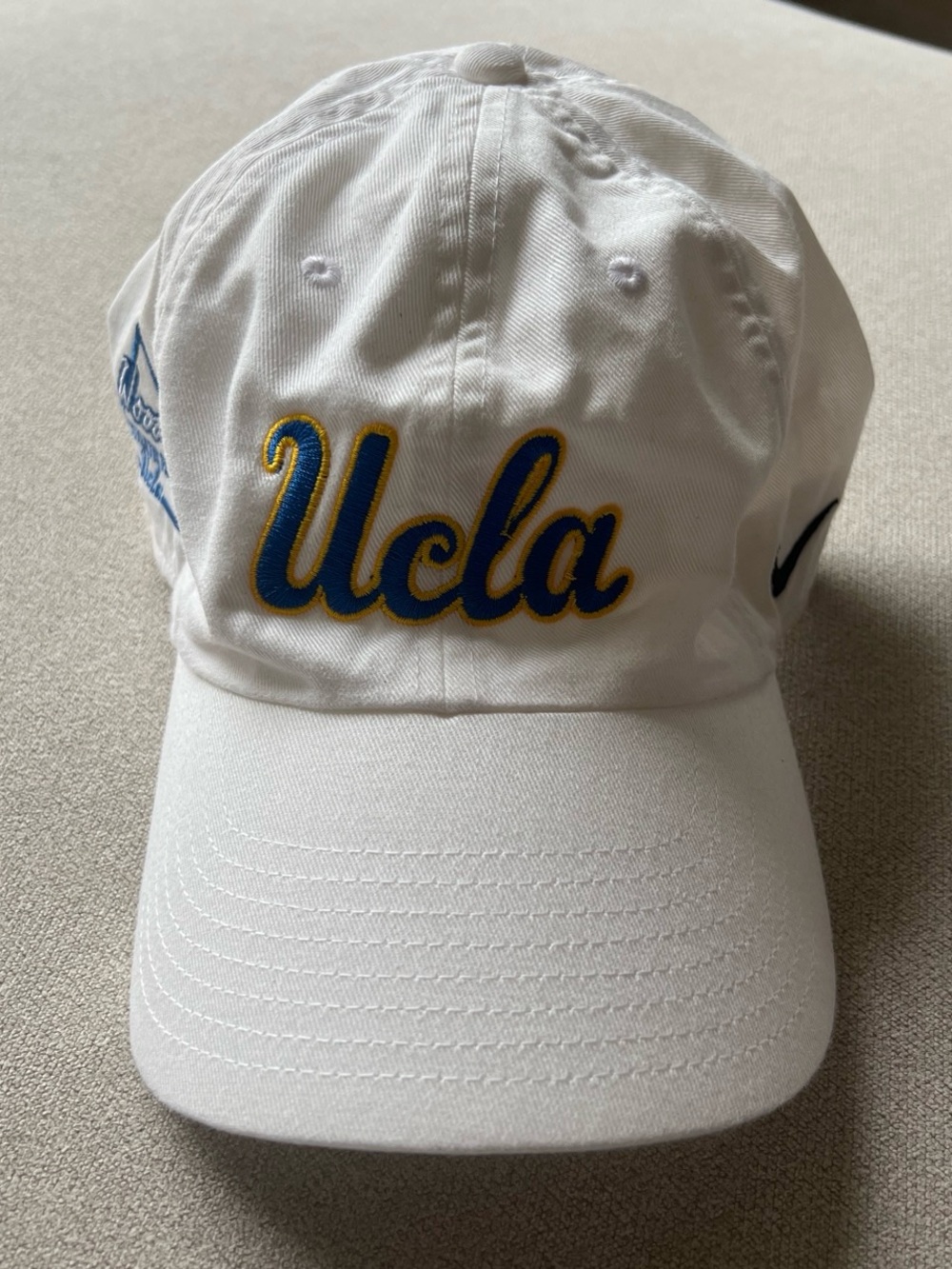 Nike White Baseball Cap with Blue and Gold Embroidered Script